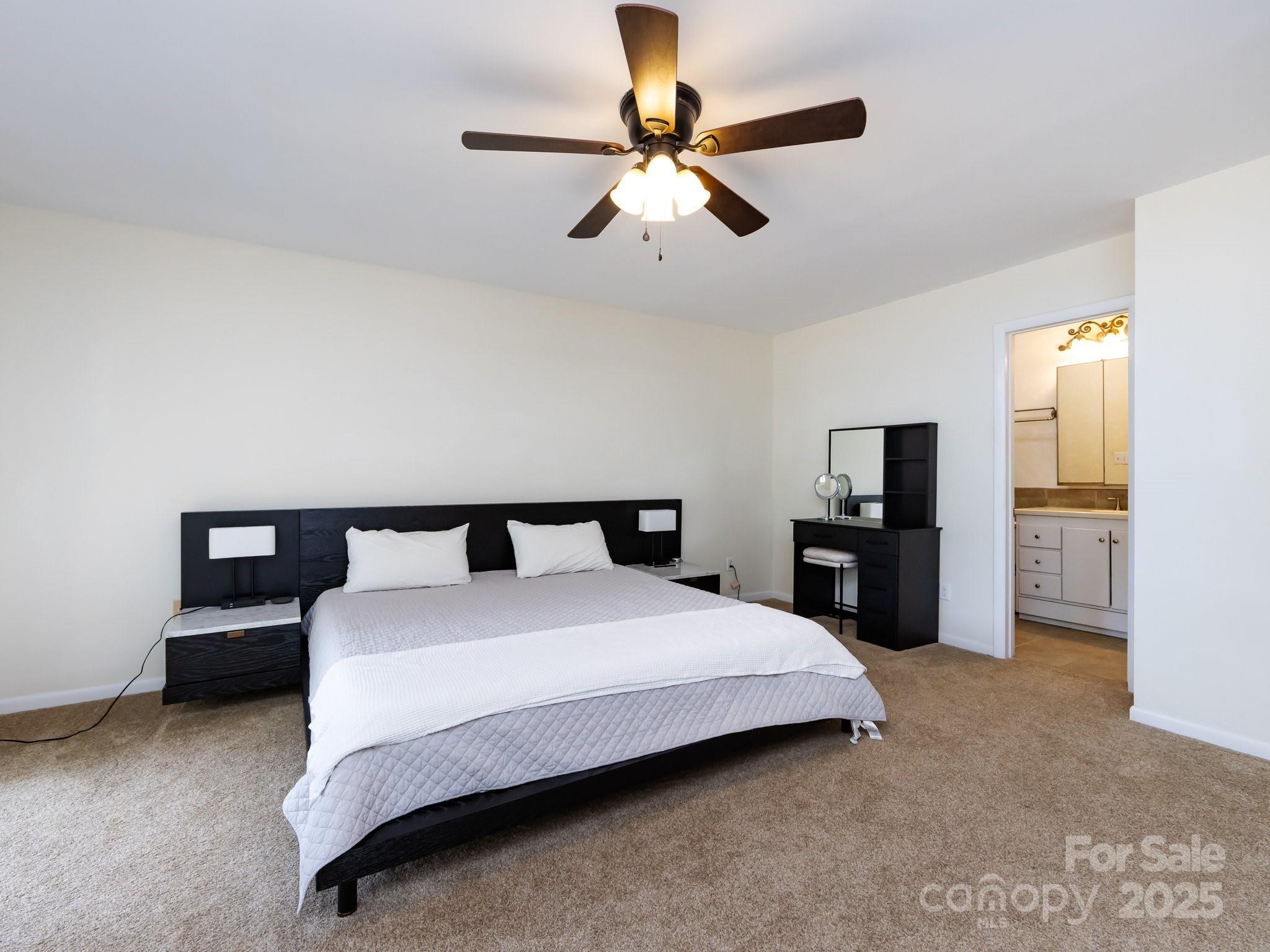 5809 Sharon Road, Unit G Charlotte, NC 28210 - Photo 13 of 25 a bedroom with a bed and a chandelier