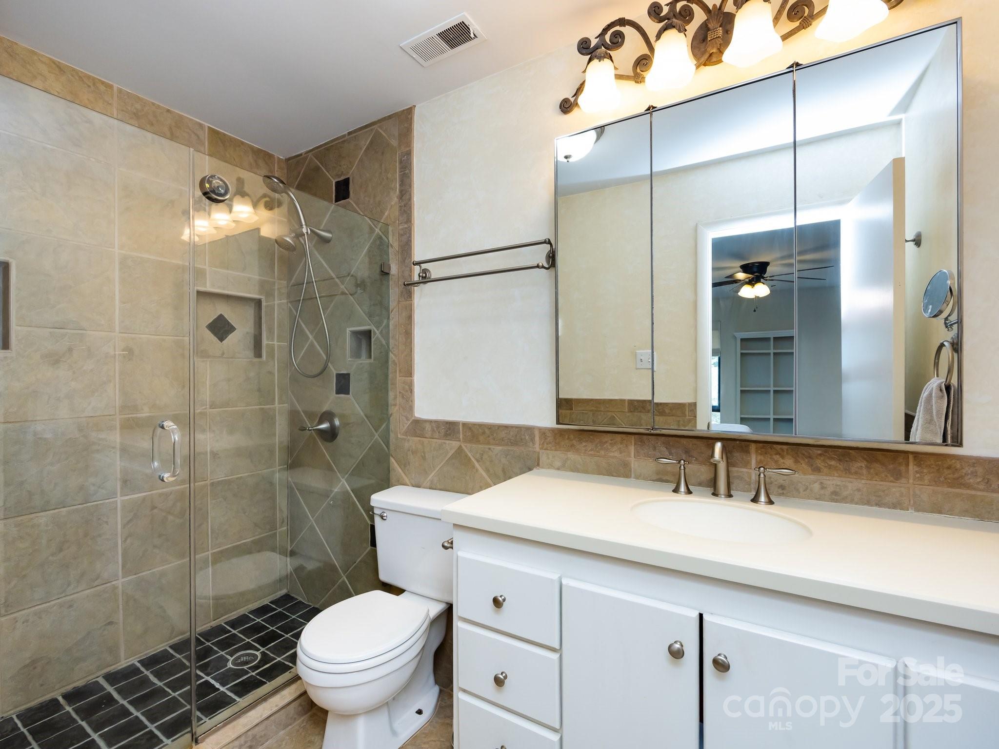 5809 Sharon Road, Unit G Charlotte, NC 28210 - Photo 14 of 25 a bathroom with a sink a toilet and shower