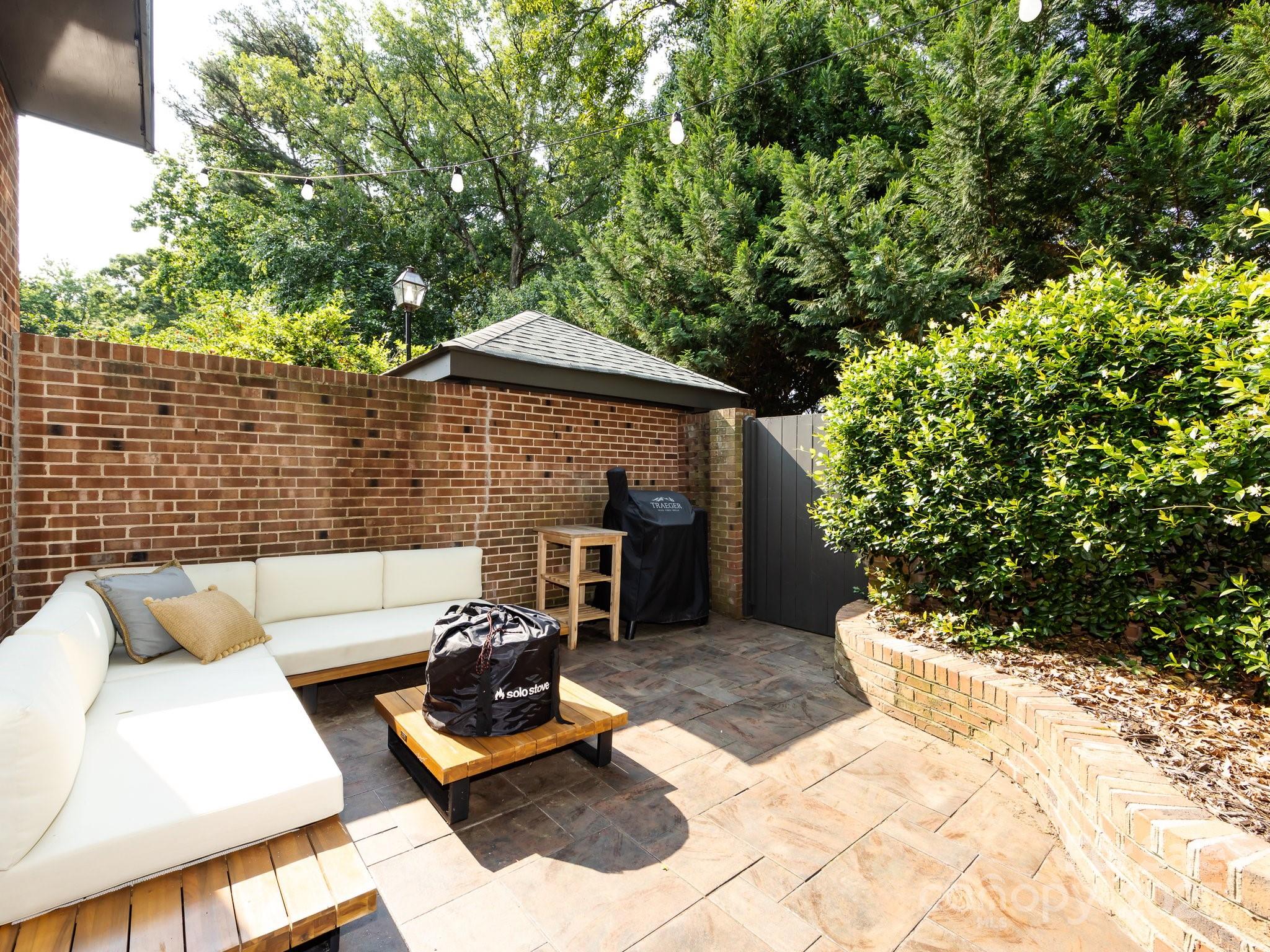 5809 Sharon Road, Unit G Charlotte, NC 28210 - Photo 20 of 25 a view of a backyard with furniture and a fire pit