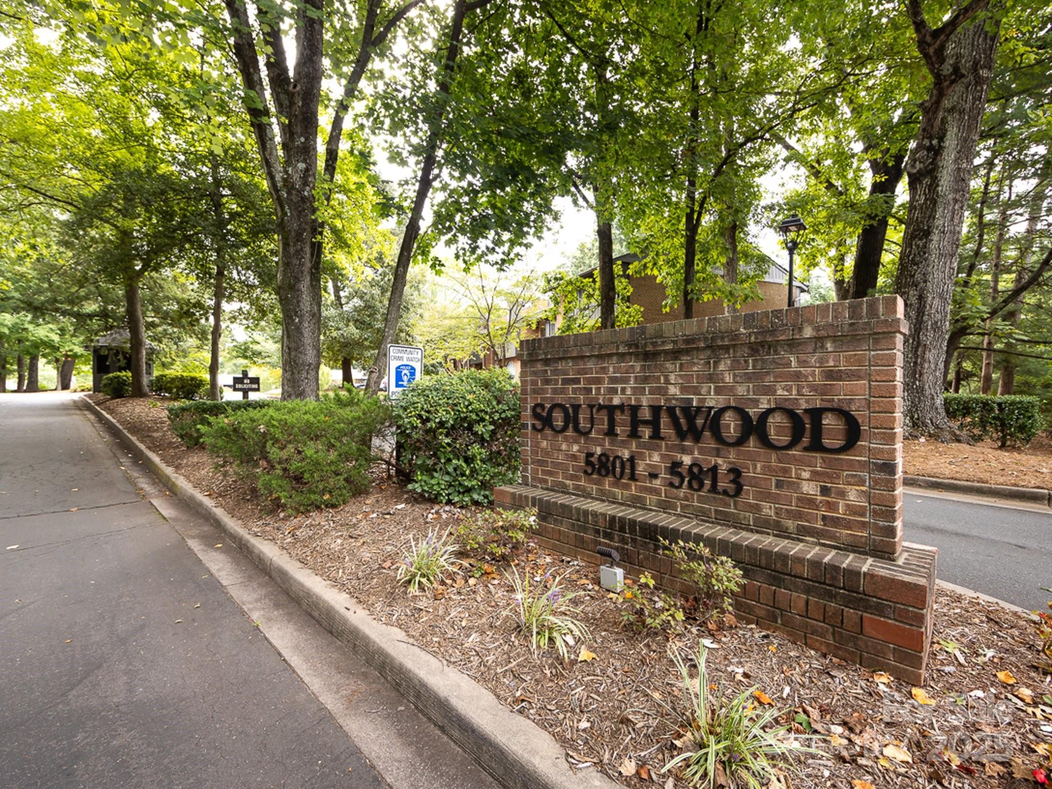 5809 Sharon Road, Unit G Charlotte, NC 28210 - Photo 25 of 25 a view of a street with trees in front of it