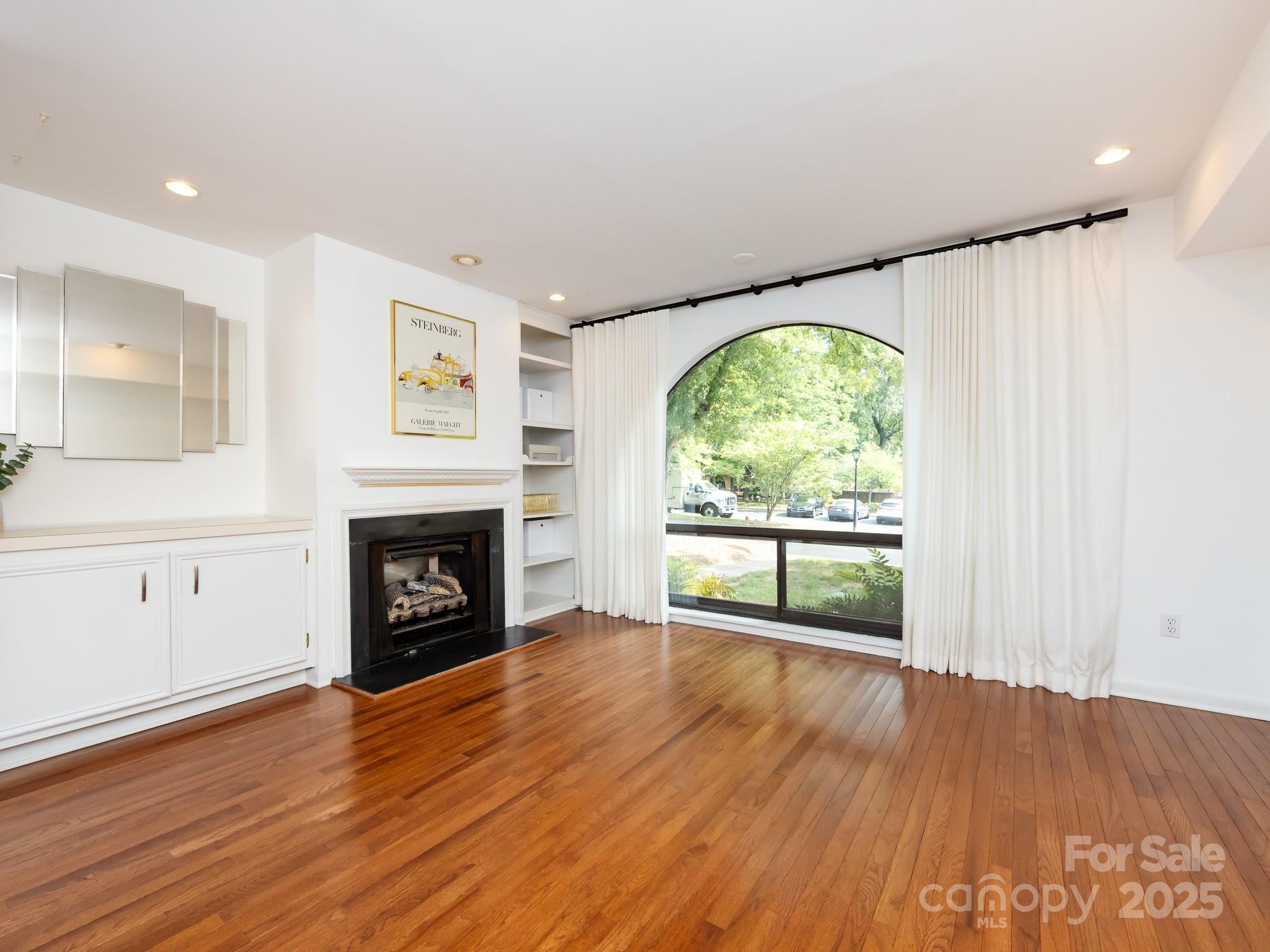 5809 Sharon Road, Unit G Charlotte, NC 28210 - Photo 3 of 25 an empty room with windows fire place and fireplace
