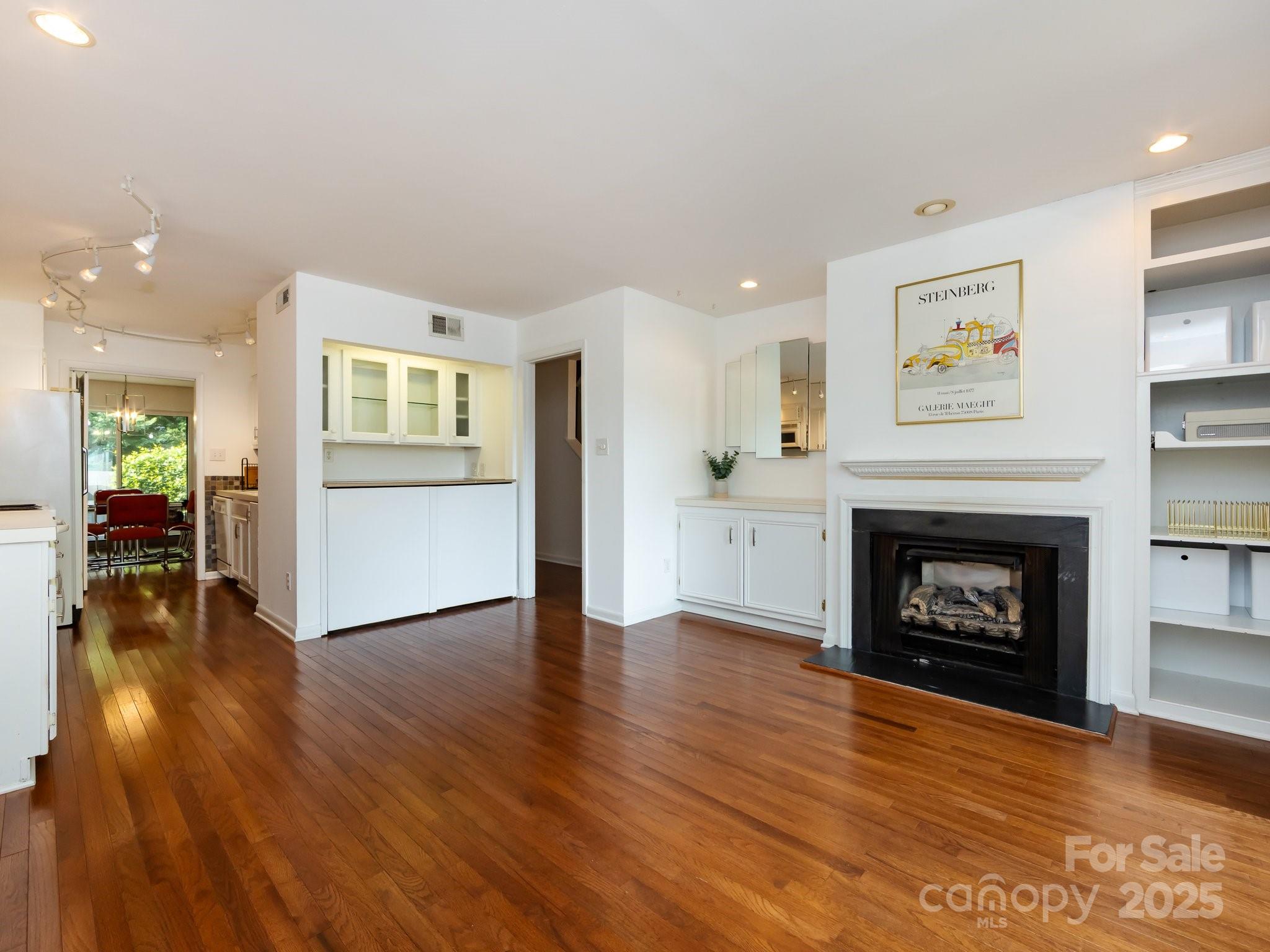 5809 Sharon Road, Unit G Charlotte, NC 28210 - Photo 4 of 25 a view of a livingroom with wooden floor and a fireplace
