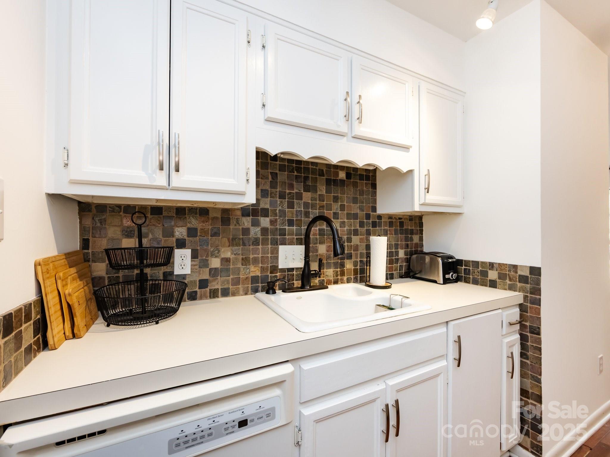 5809 Sharon Road, Unit G Charlotte, NC 28210 - Photo 7 of 25 a kitchen with a sink and cabinets