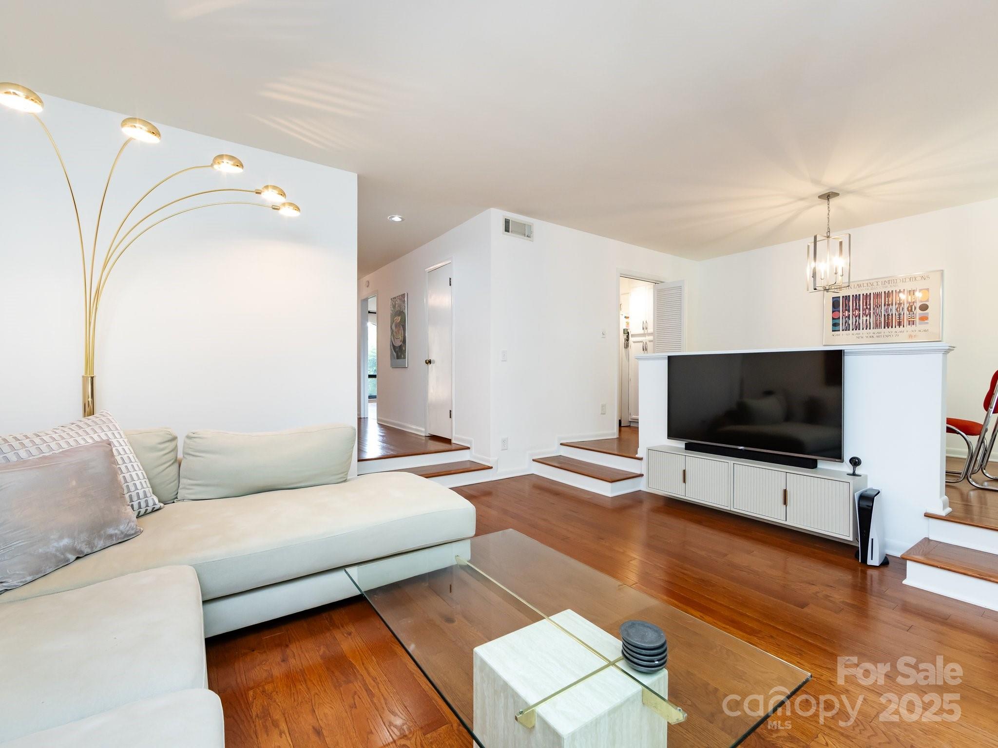 5809 Sharon Road, Unit G Charlotte, NC 28210 - Photo 10 of 25 a living room with furniture and a flat screen tv