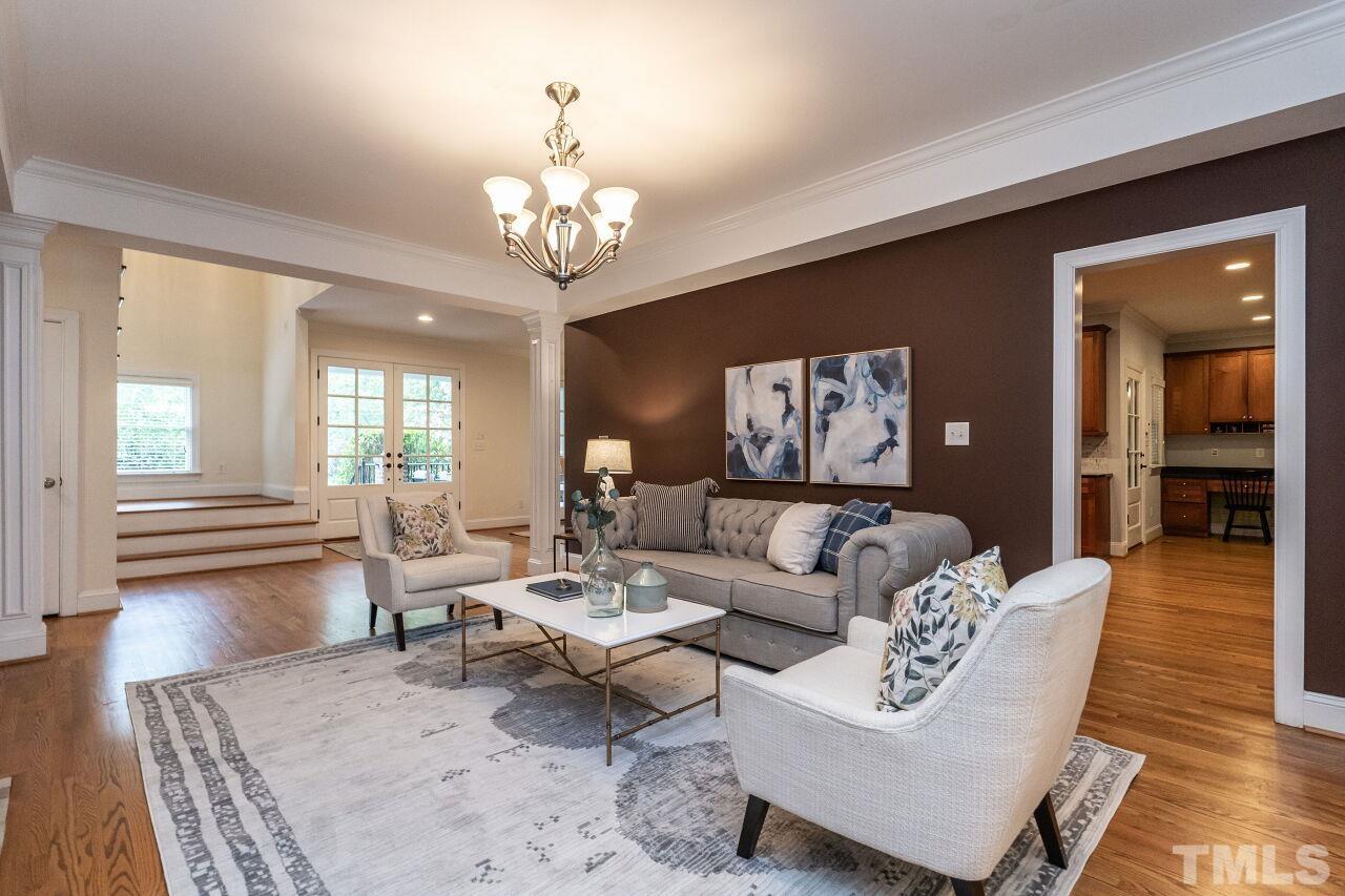 2730 Rothgeb Drive Raleigh, NC 27609 - Photo 11 of 43 a living room with furniture wooden floor and a chandelier