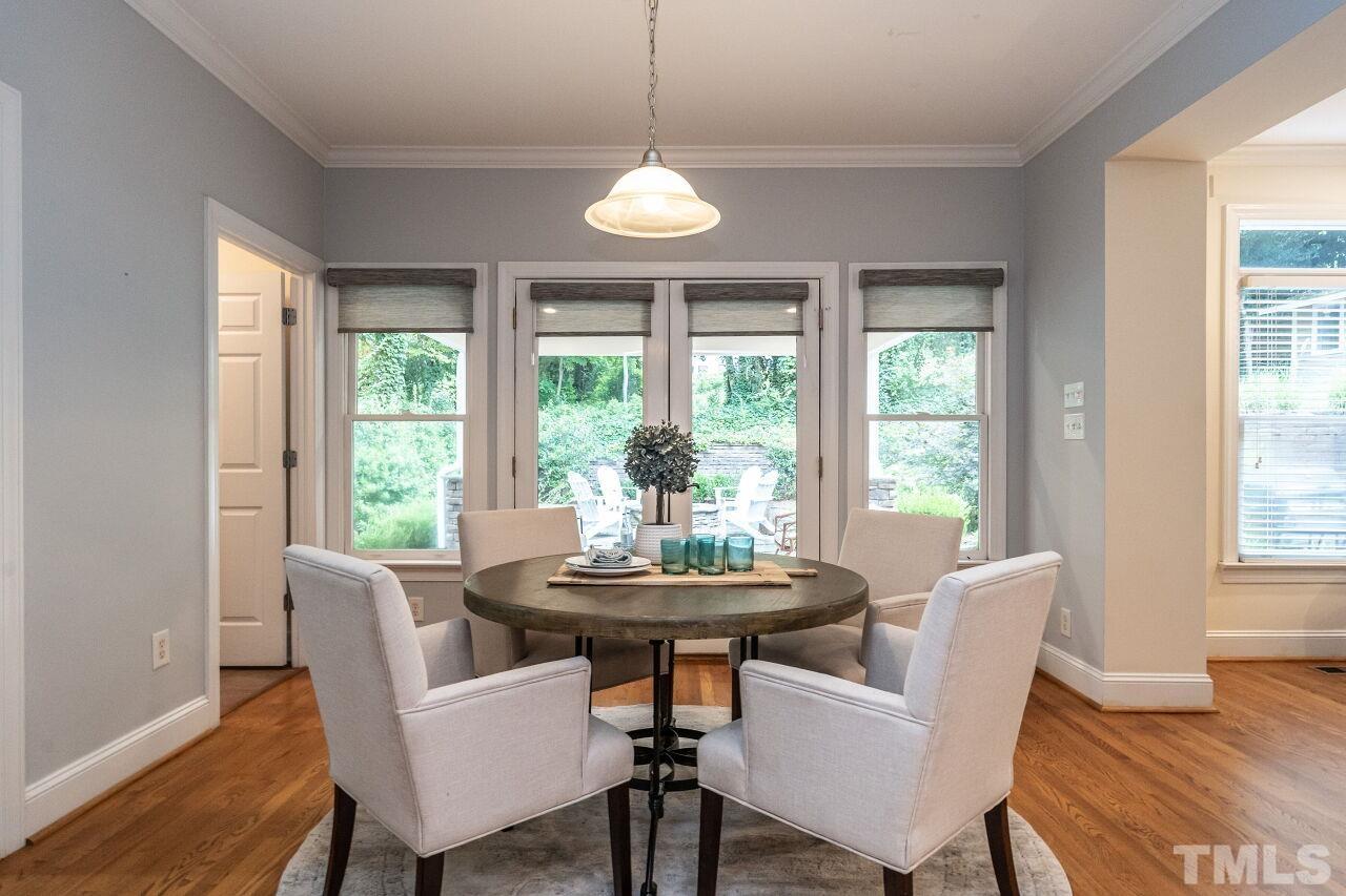 2730 Rothgeb Drive Raleigh, NC 27609 - Photo 14 of 43 a dining room with furniture a chandelier and wooden floor