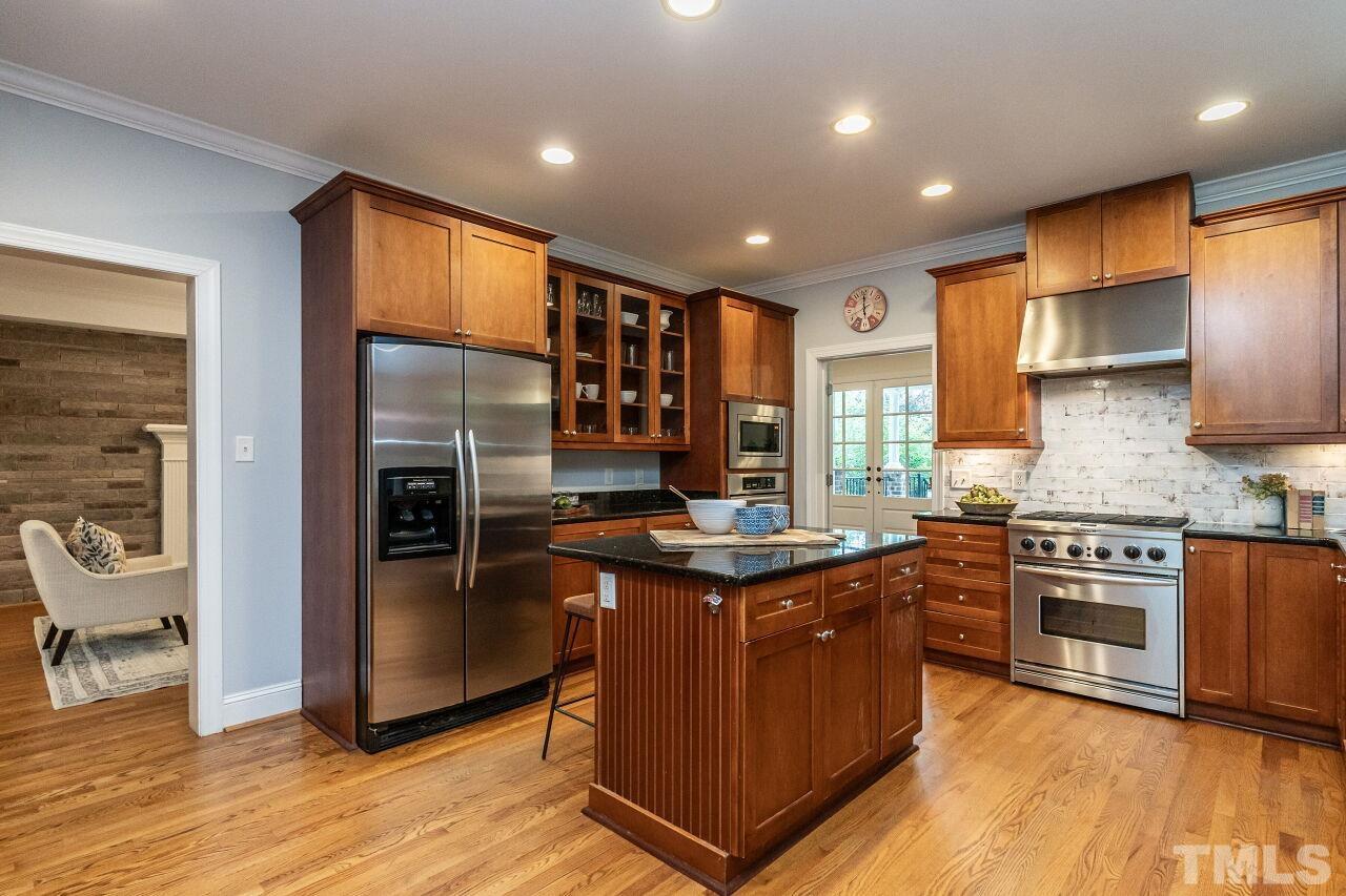 2730 Rothgeb Drive Raleigh, NC 27609 - Photo 17 of 43 a kitchen with stainless steel appliances granite countertop a stove a refrigerator a sink and a microwave