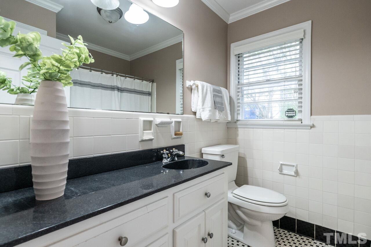 2730 Rothgeb Drive Raleigh, NC 27609 - Photo 23 of 43 a bathroom with a sink a toilet and window