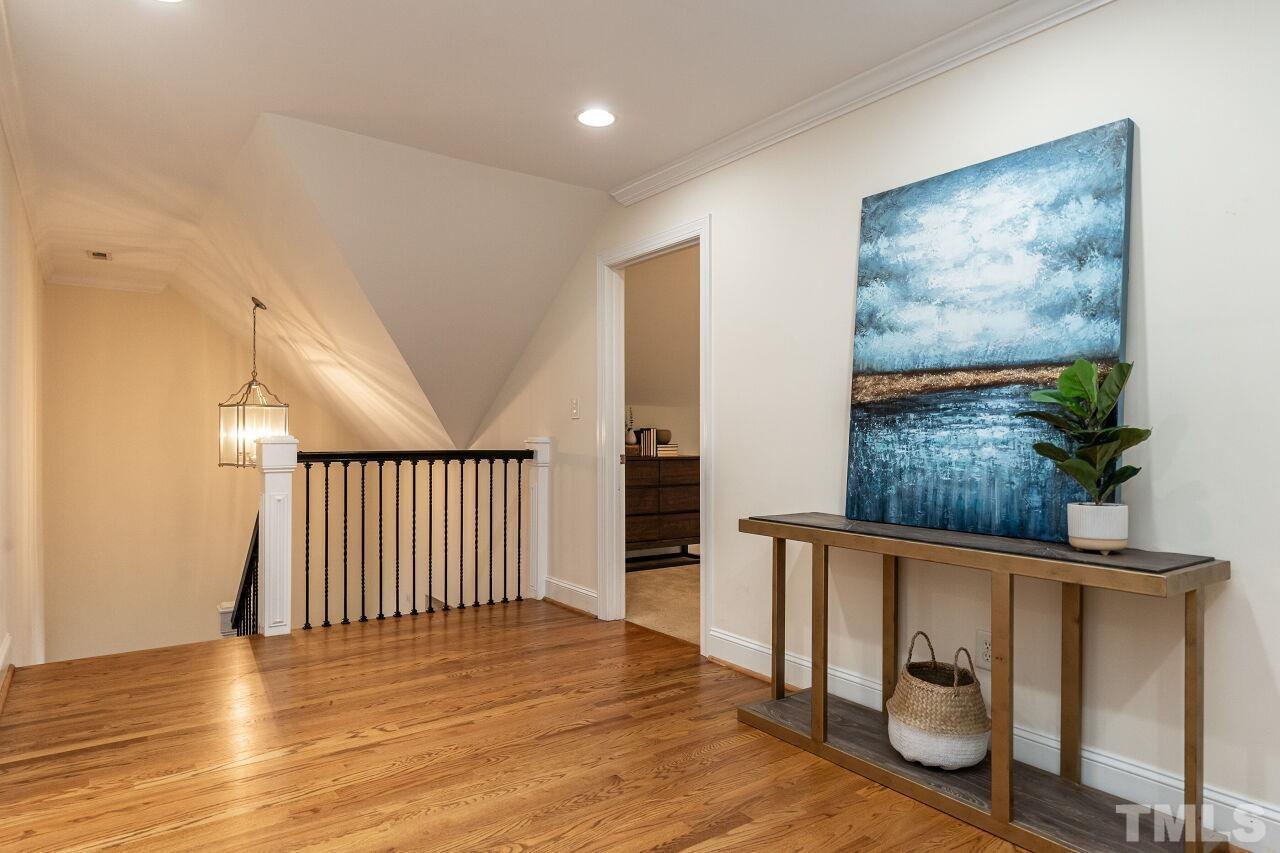 2730 Rothgeb Drive Raleigh, NC 27609 - Photo 26 of 43 a view of a hallway with wooden floor and a potted plant