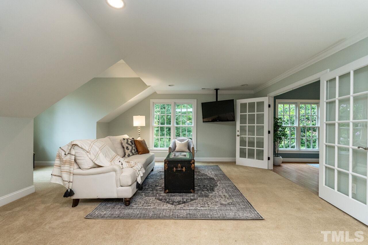 2730 Rothgeb Drive Raleigh, NC 27609 - Photo 28 of 43 a living room with furniture large window and flat screen tv