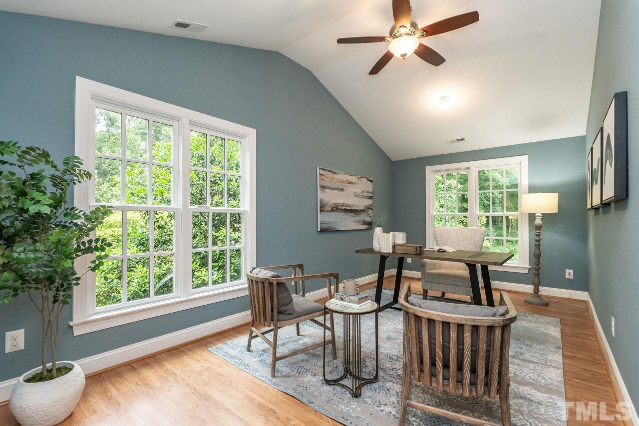 2730 Rothgeb Drive Raleigh, NC 27609 - Photo 30 of 43 a dining room with chandelier fan and wooden floor