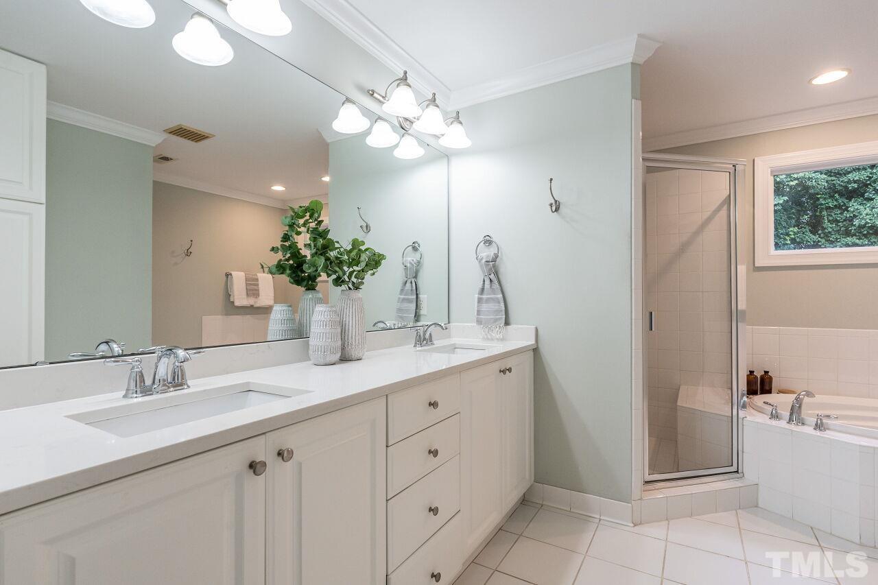 2730 Rothgeb Drive Raleigh, NC 27609 - Photo 31 of 43 a bathroom with a tub sink and mirror