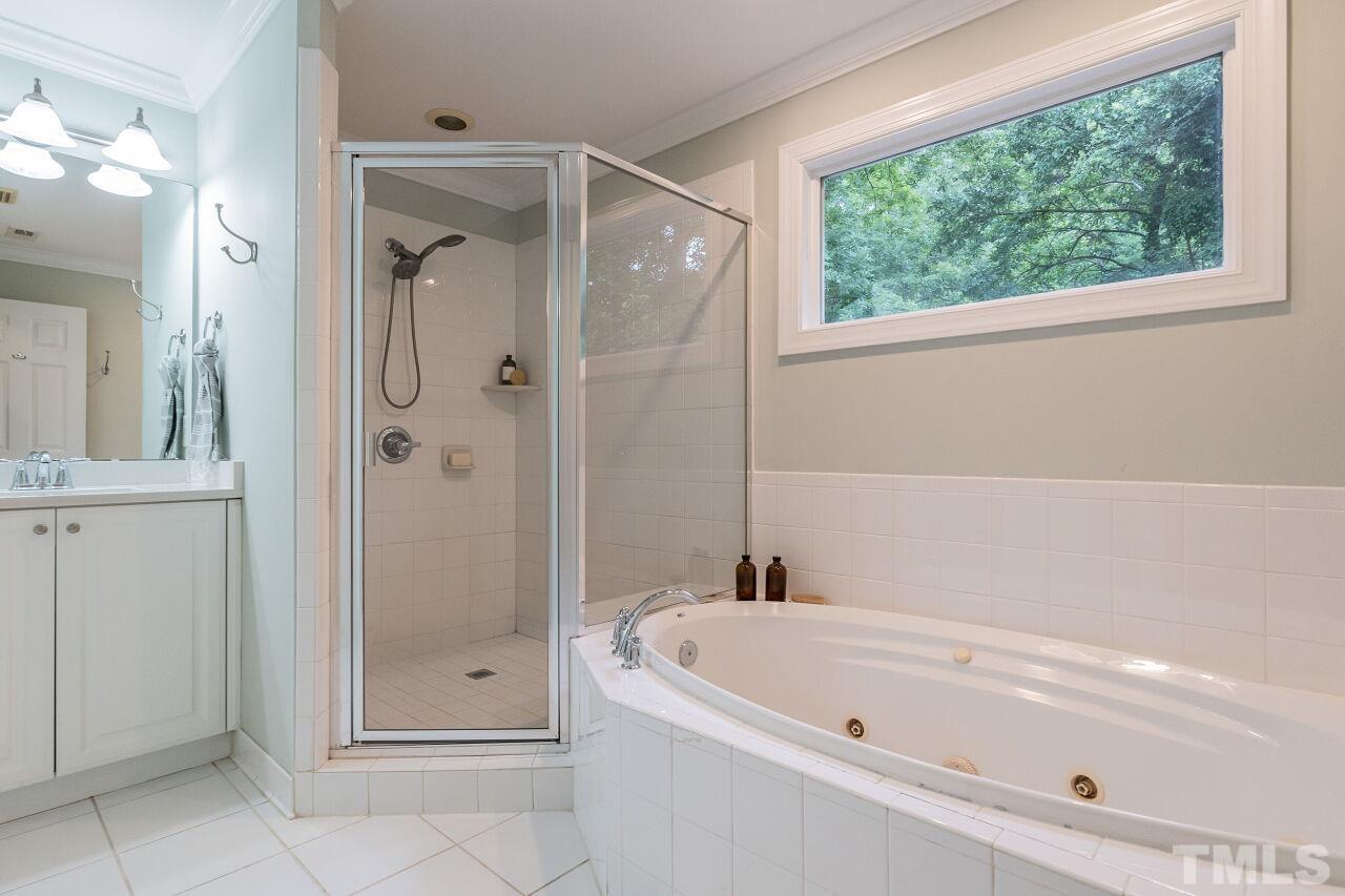 2730 Rothgeb Drive Raleigh, NC 27609 - Photo 32 of 43 a bathroom with a tub shower and toilet