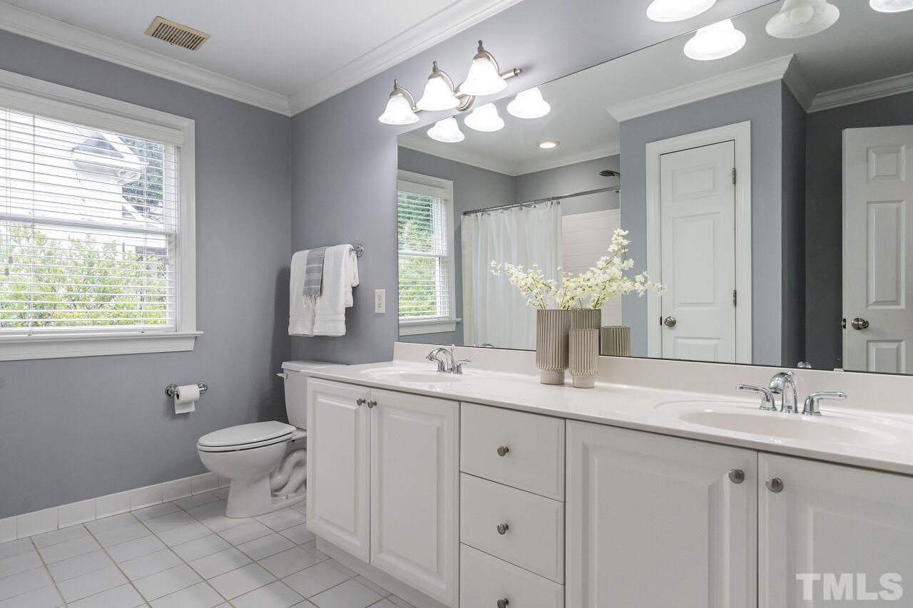 2730 Rothgeb Drive Raleigh, NC 27609 - Photo 36 of 43 a bathroom with a double vanity sink and a mirror