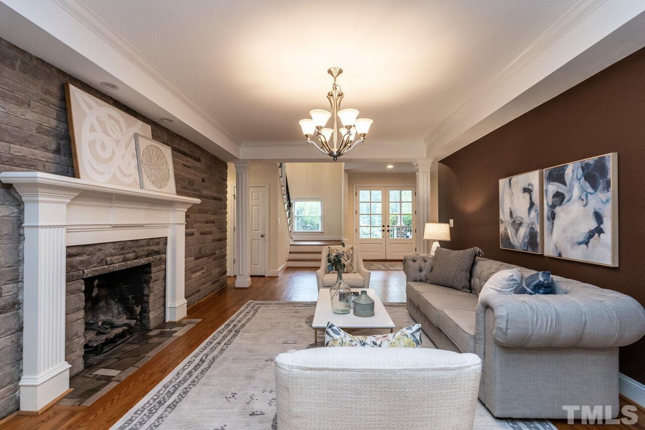 2730 Rothgeb Drive Raleigh, NC 27609 - Photo 8 of 43 a living room with furniture and a fireplace