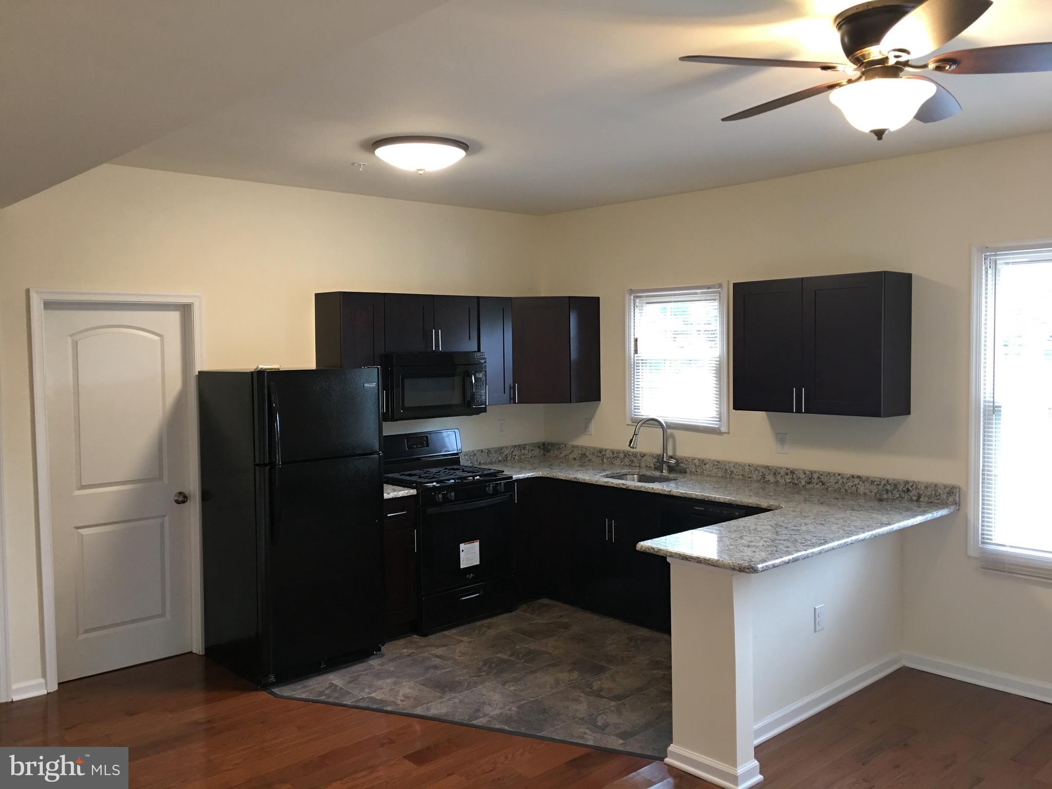 357 Oakwood Avenue, Unit 204 Glassboro, NJ 08028 - Photo 13 of 18 a kitchen with cabinets and stainless steel appliances