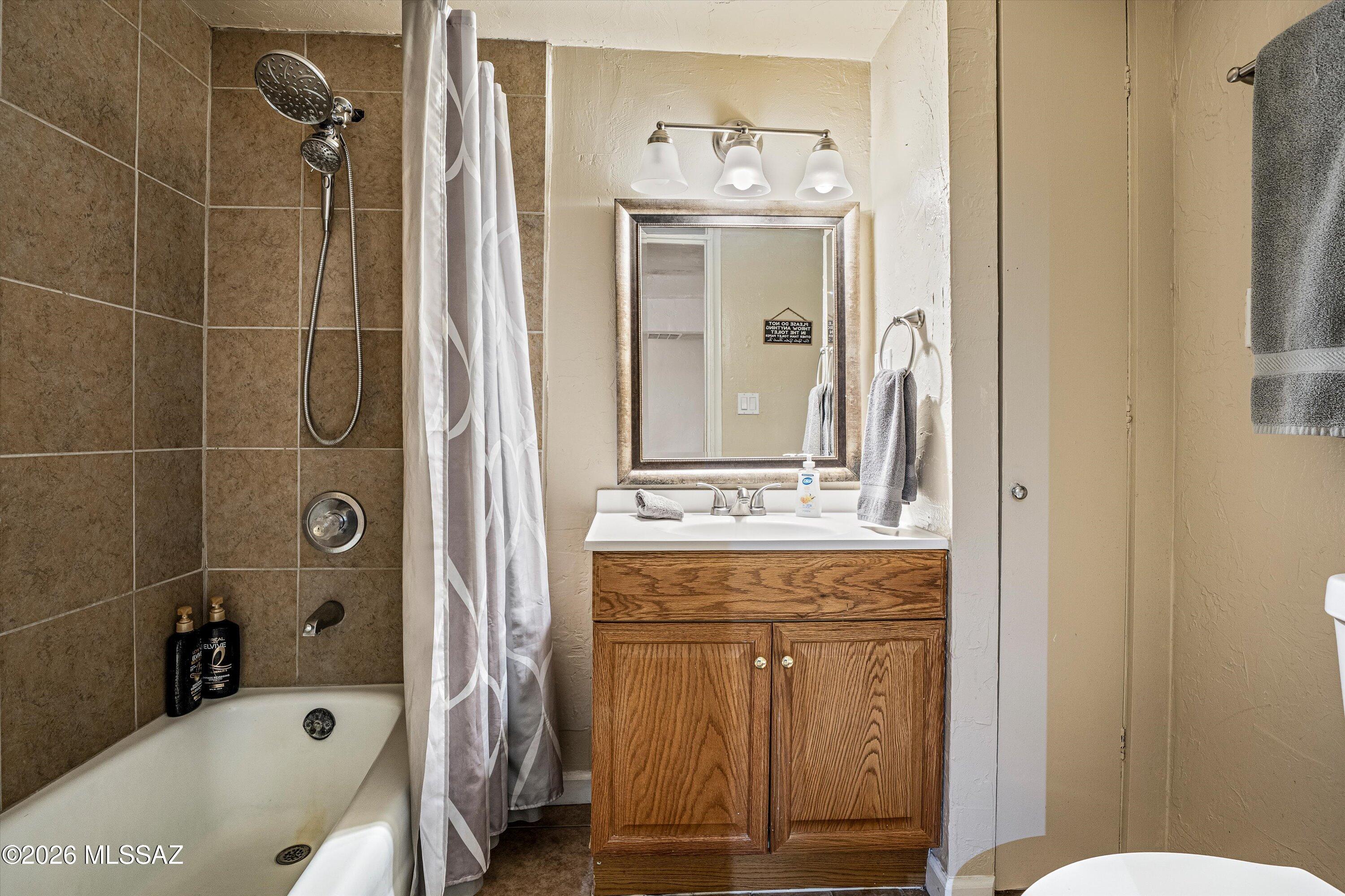 2619 East Prince Road Tucson, AZ 85716 - Photo 46 of 50 a bathroom with a tub mirror and a sink