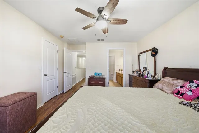 a bed room with a bed and a chandelier