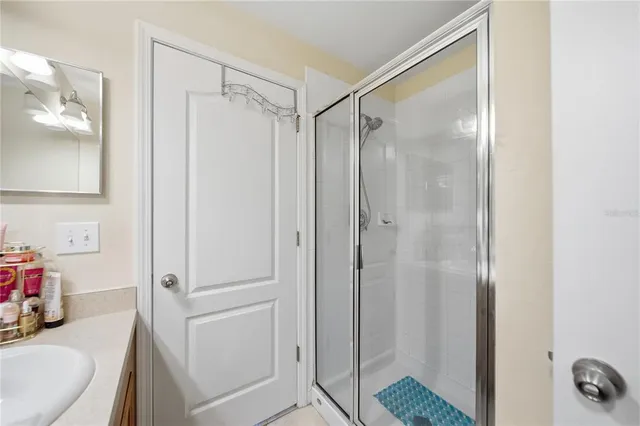 a bathroom with a shower and a sink