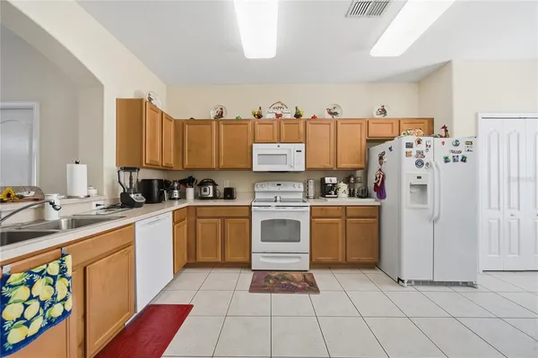 a kitchen with a white cabinets and white appliances