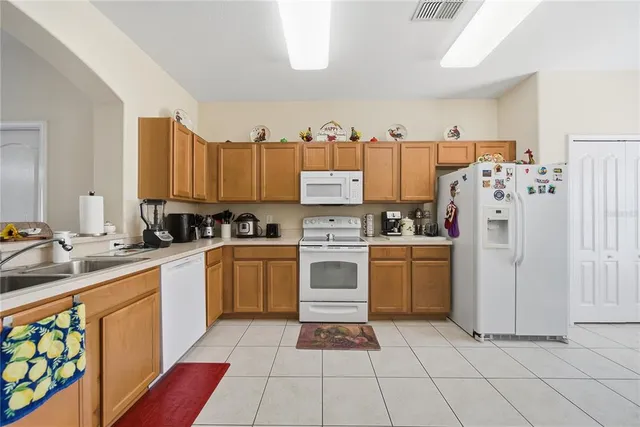 a kitchen with a white cabinets and white appliances