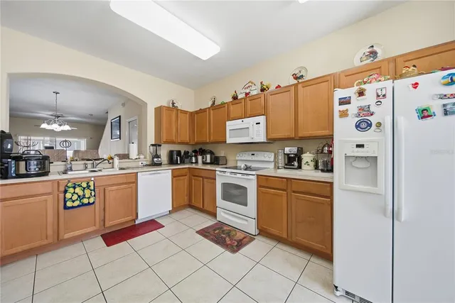 a kitchen with granite countertop appliances and cabinets