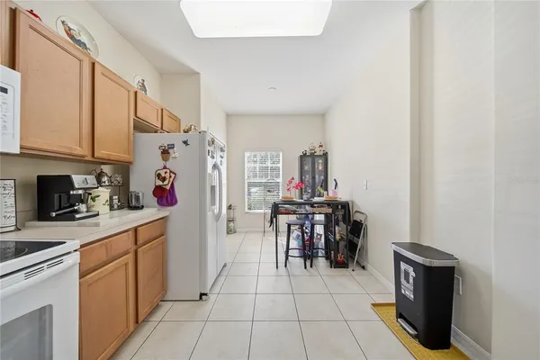 a kitchen with a sink a stove and chairs