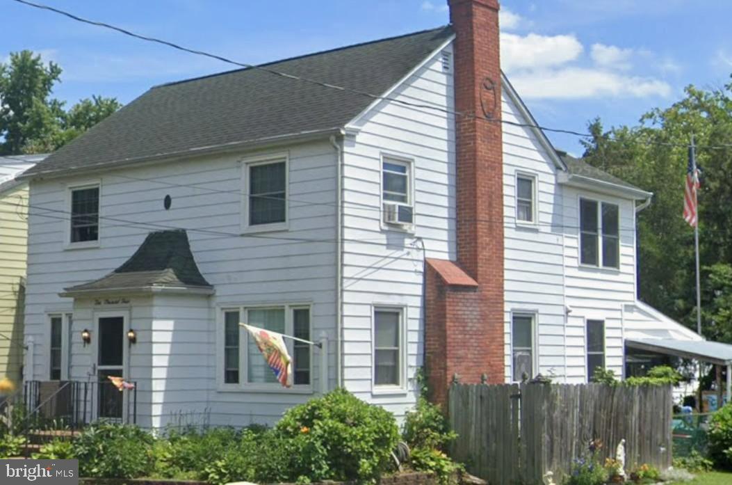 a front view of a house with plants