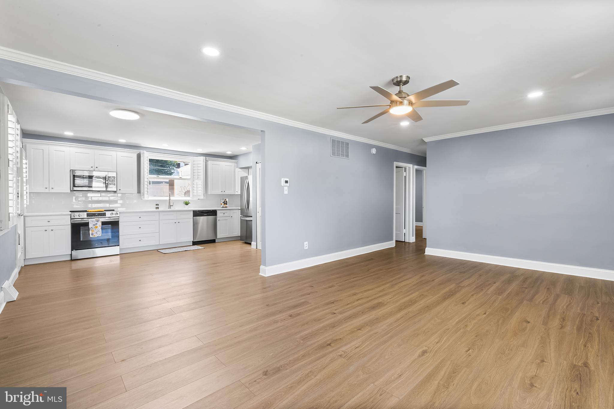 343 A Sugartown Road, Unit A Wayne, PA 19087 - Photo 3 of 11 a view of an empty room and kitchen view with wooden floor