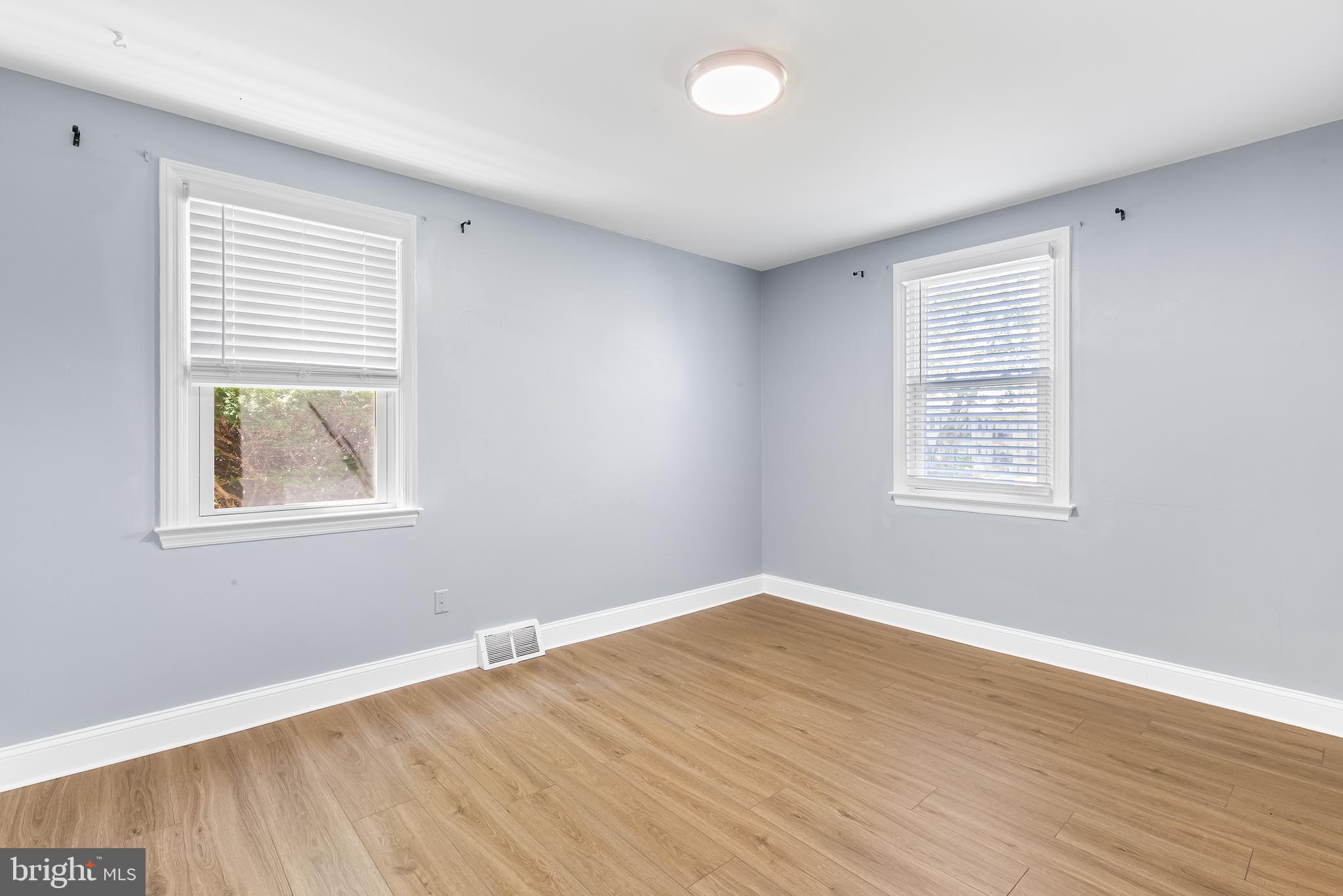 343 A Sugartown Road, Unit A Wayne, PA 19087 - Photo 9 of 11 a view of an empty room with wooden floor and a window