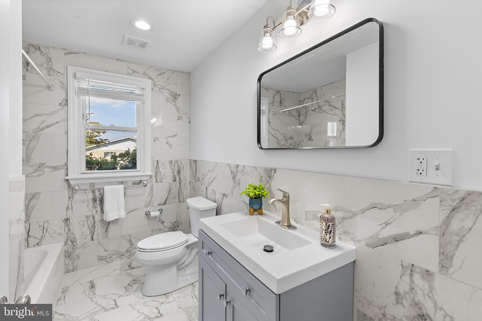 343 A Sugartown Road, Unit A Wayne, PA 19087 - Photo 10 of 11 a bathroom with a toilet a sink and mirror