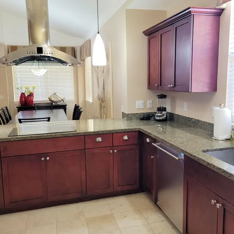 a kitchen with stainless steel appliances granite countertop a sink and cabinets