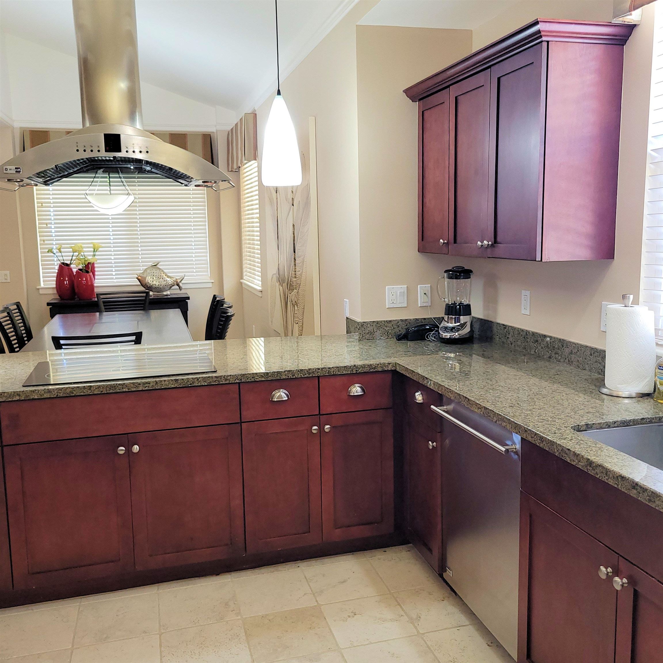 83 Kainehe Place, Unit 9B Kihei, HI 96753 - Photo 11 of 23 a kitchen with stainless steel appliances granite countertop a sink and cabinets