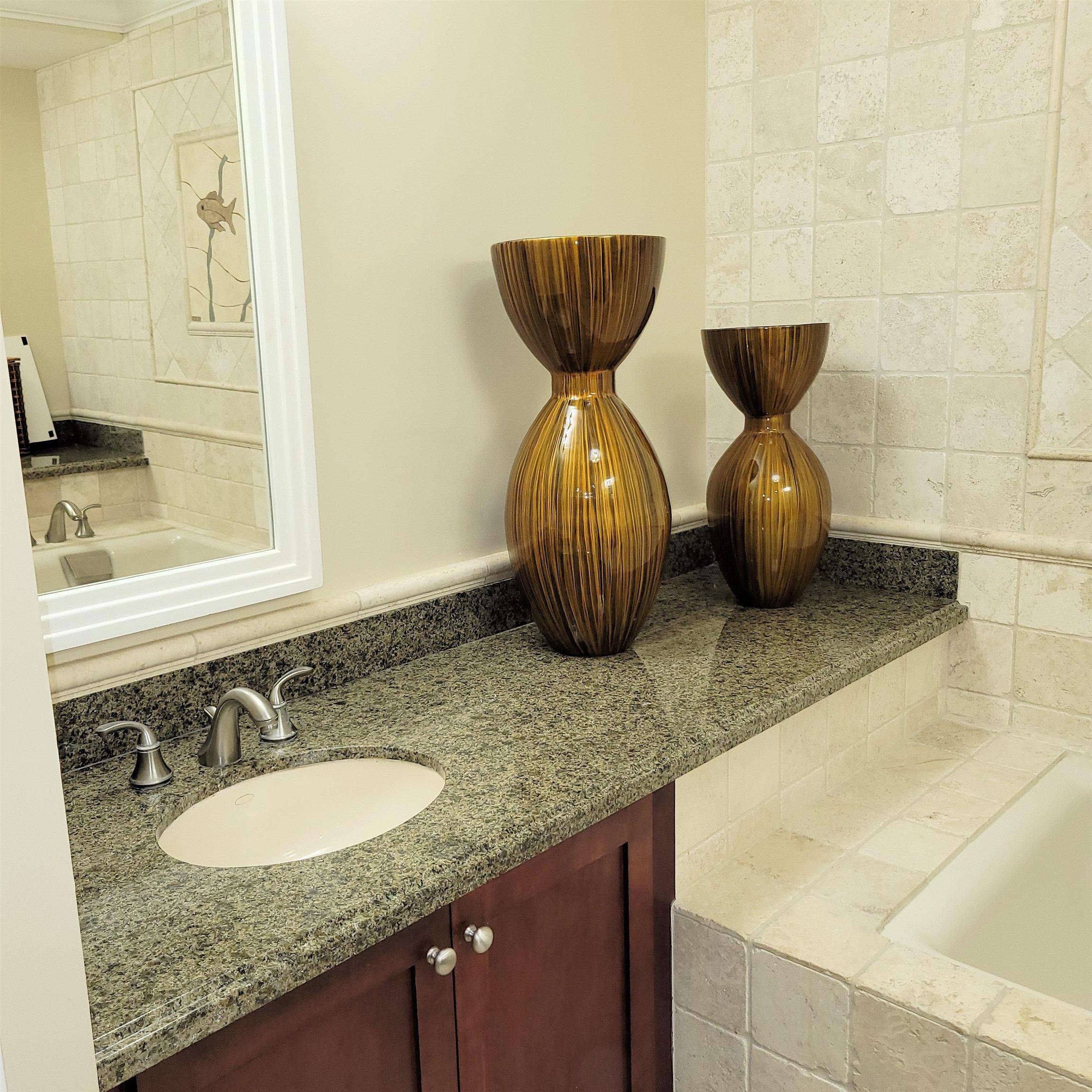 83 Kainehe Place, Unit 9B Kihei, HI 96753 - Photo 17 of 23 a bathroom with a granite countertop sink and a mirror