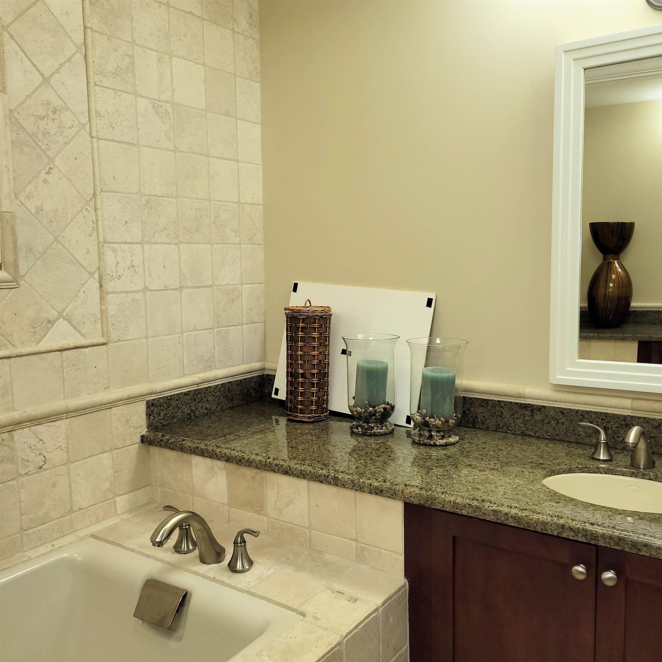 83 Kainehe Place, Unit 9B Kihei, HI 96753 - Photo 18 of 23 a bathroom with a granite countertop sink and a mirror