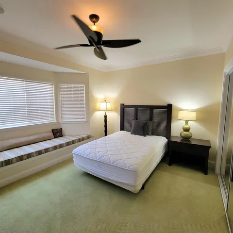 a bedroom with a bed and window