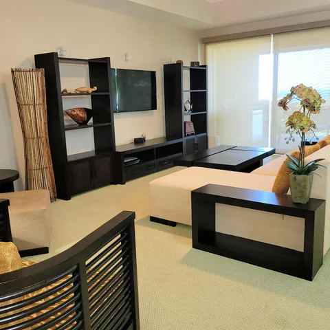 a bedroom with furniture and flat screen tv