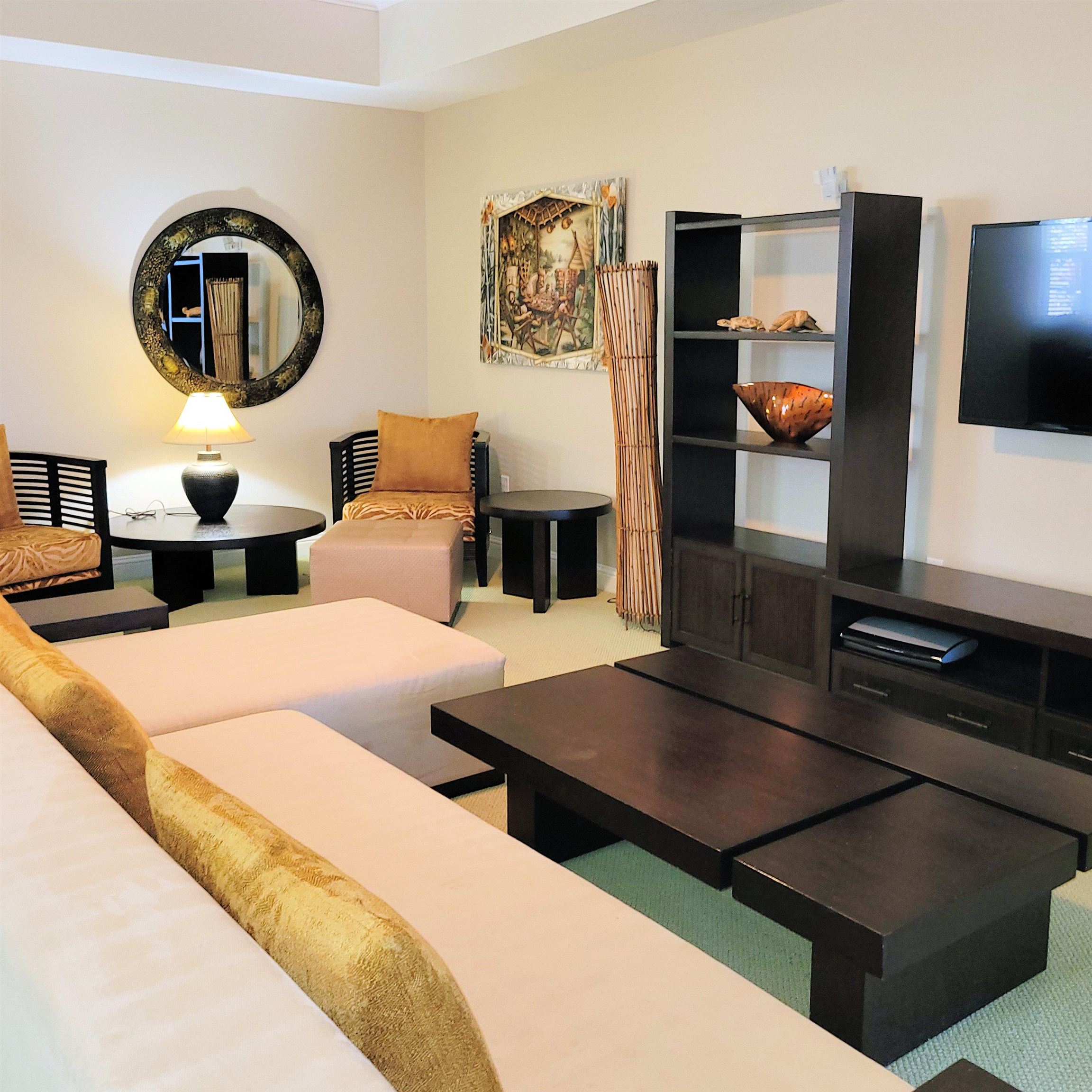 83 Kainehe Place, Unit 9B Kihei, HI 96753 - Photo 7 of 23 a living room with furniture and a mirror