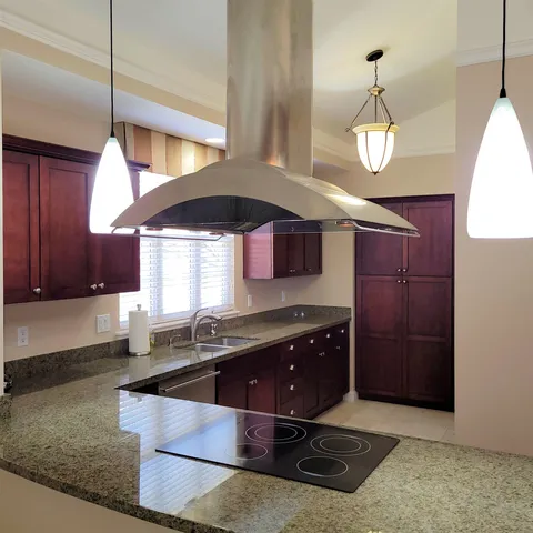 a kitchen with a sink a cabinets and window