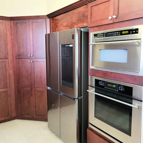 a kitchen with a stove and a refrigerator