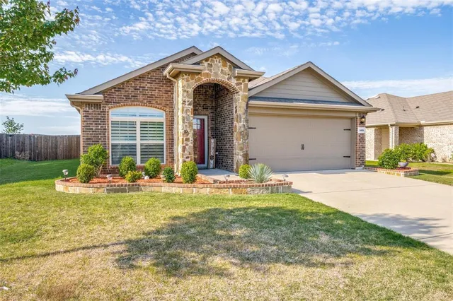 a front view of a house with swimming pool and yard