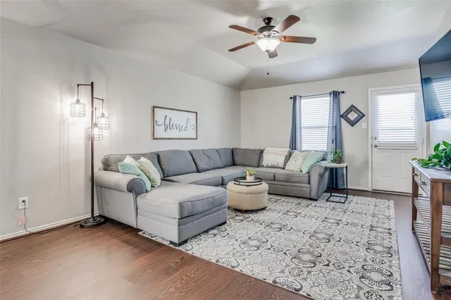a living room with furniture and a chandelier