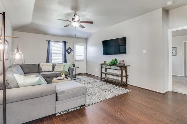 a living room with furniture and a flat screen tv