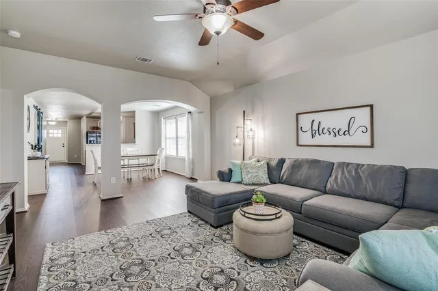 a living room with furniture and a chandelier