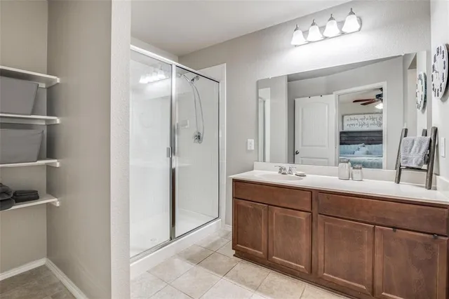a bathroom with a double vanity sink mirror and bathtub