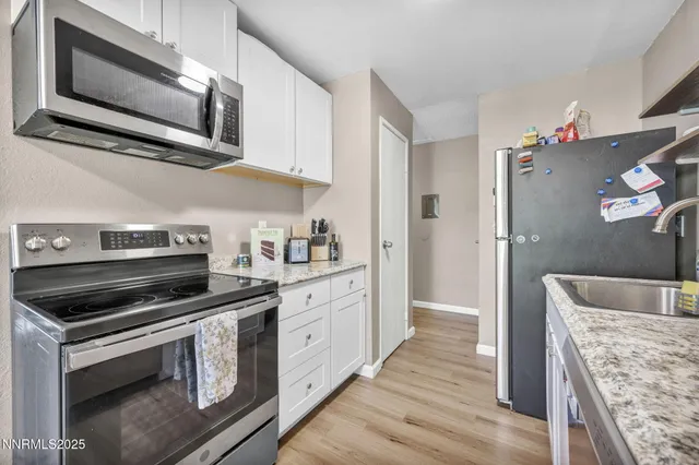 a kitchen with stainless steel appliances granite countertop a stove microwave and refrigerator
