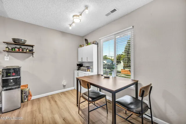 a view of a workspace with furniture and a window