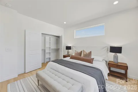 a bedroom with a bed and a lamp