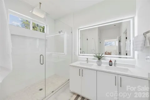 a bathroom with double vanity sink and a mirror
