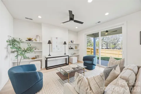 a bedroom with furniture and a large window